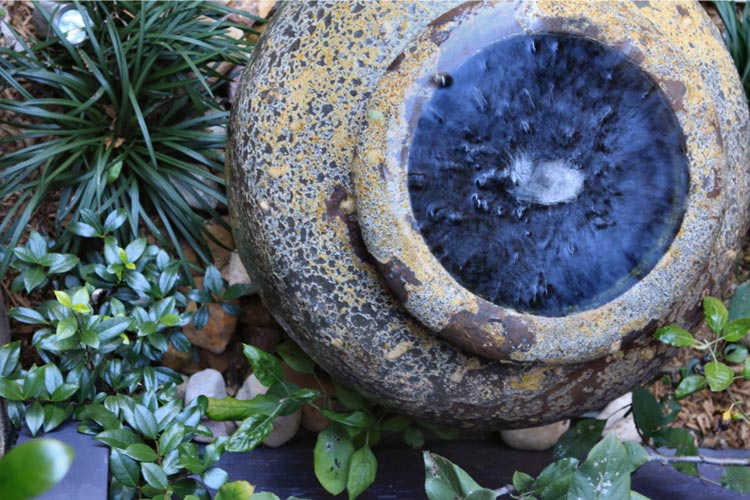 Close up of water feature in garden bed
