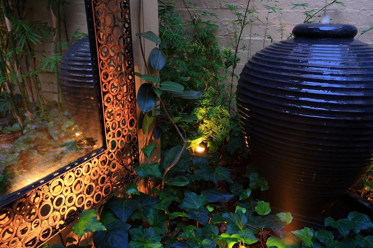 Backyard landscape design water feature with mirror