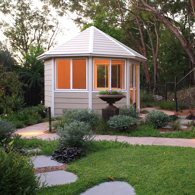 Summer house nestled into a native garden