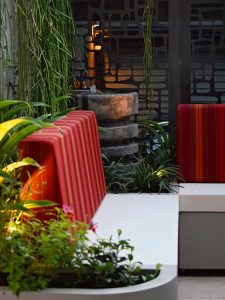 water feature among plantings next to the bespoke concrete seating