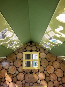 Inside the cubby house with the insects in the roof