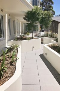 Raised garden beds with rendered, rounded corners to soften the area
