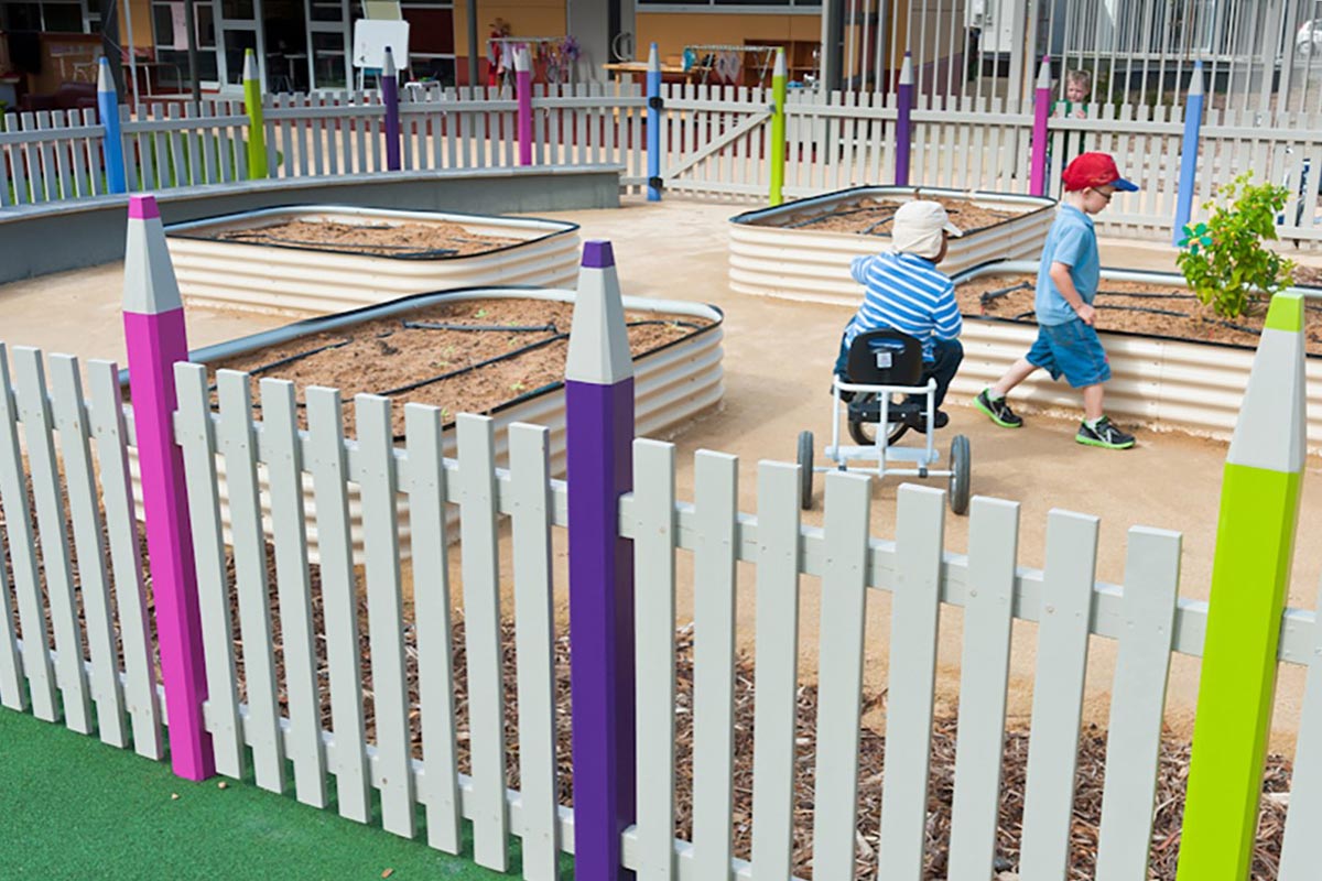 A vegetable garden enclosed by a pencil picket fence