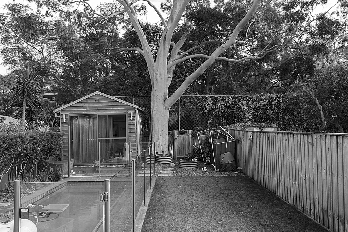 Before image of pool, lawn area and studio room