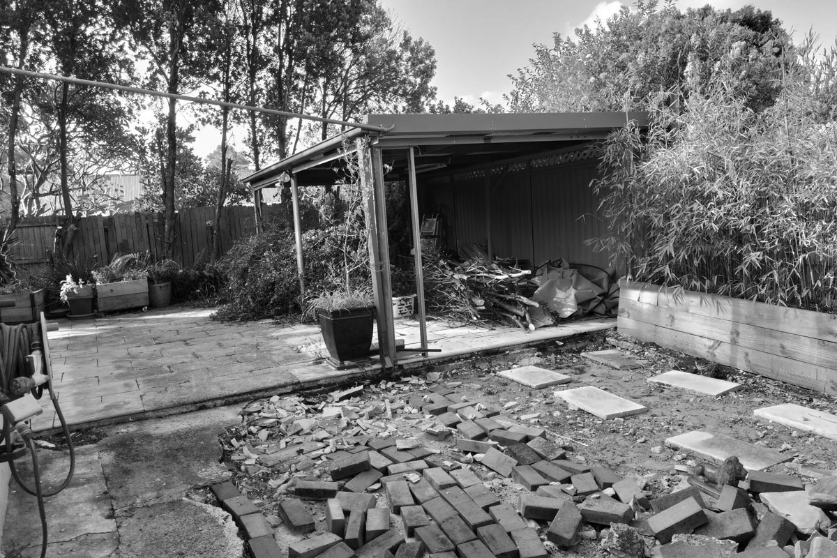 Before shot of the garden showing rubbish.